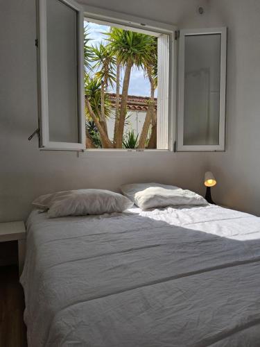 une chambre avec un grand lit avec une fenêtre dans l'établissement Le barracuda du port, à Port-la-Nouvelle