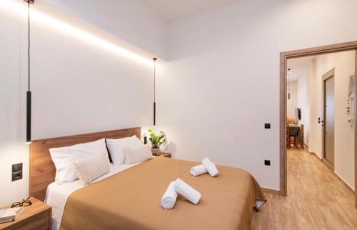 a bedroom with a large bed with towels on it at Pnoe Home Tinos in Tinos