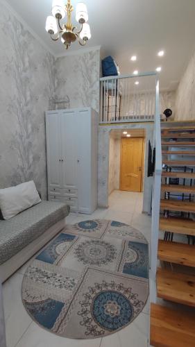 a living room with a staircase and a couch at BURABAY Promenade Solo in Borovoye