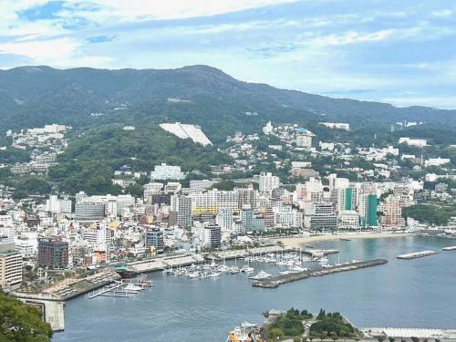 an aerial view of a city with boats in the water at マリーナベイCentral in Atami