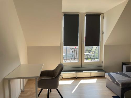 a bedroom with a desk and a chair and a window at Metro Apartment Linde Alle 14, 3Th 2720 Vanløse in Copenhagen