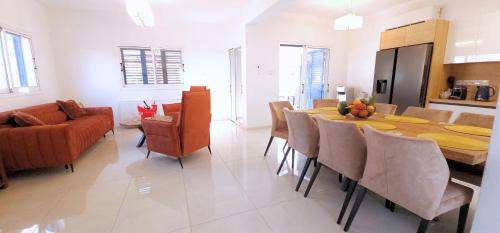 a kitchen and dining room with a table and chairs at Villa Elia Blue , hot tube , heated pool in Paralimni