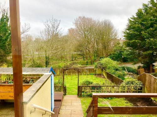 a view of a garden from the balcony of a house at Harry's in Torquay