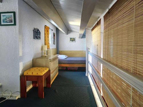 Cette petite chambre comprend un lit, une table et un banc. dans l'établissement Appartement climatisé pour 5 pers avec terrasse, à 900m de la plage et parking privatif - FR-1-607-66, au Cap d'Agde