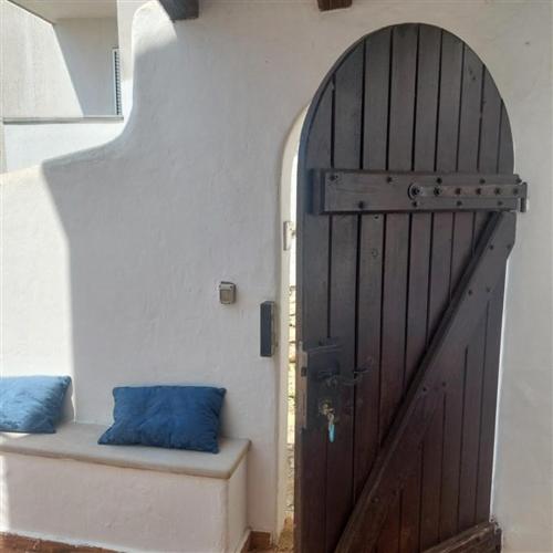 a room with a door and a bench with a blue pillow at Apartment Arte by in Pješčana Uvala 