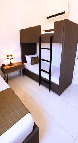 a bedroom with a bunk bed and a table at Villa Elia Blue , hot tube , heated pool in Paralimni