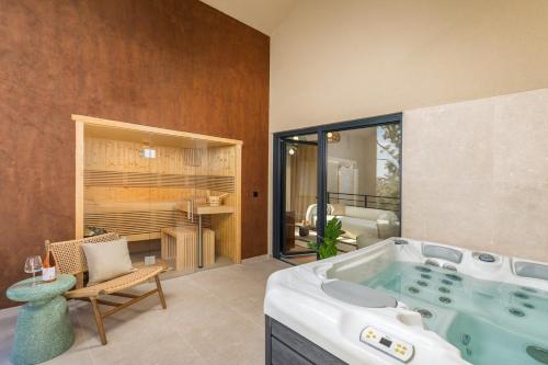 a large bathroom with a tub in a room at Villa Mol by Villsy - with private pool, sauna, jacuzzi in Baderna