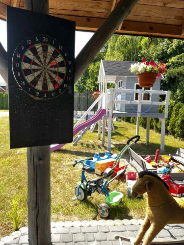 a dart board with a dog next to a playground at Pokoje Gościnne Ontario Mieroszyno in Jastrzębia Góra