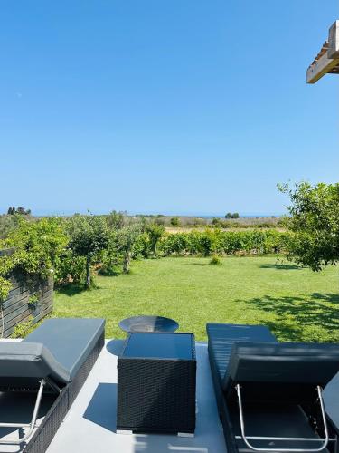 a patio with chairs and a view of a yard at L'Armino in Otranto