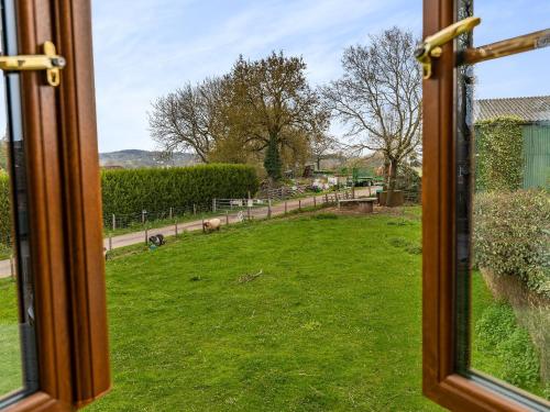 an open window with a view of a field of grass at The Lodge in Lydney