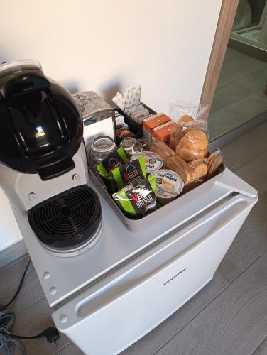 a counter with a mixer and some food and bread at Clausis in Parghelia