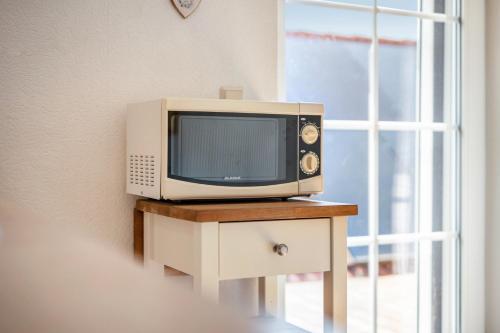 a tv sitting on a table next to a window at Ferienwohnung 2 Schulze in Neustrelitz