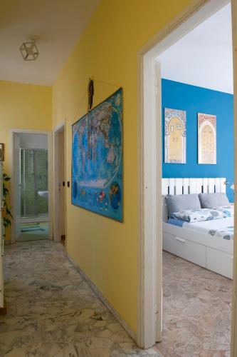 a bedroom with a bed and a painting on the wall at Florence Station Guesthouse in Florence
