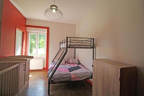 a bedroom with a bunk bed and a window at Le paradis de caux in Magnac-Bourg