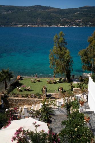 a view of a lawn with the ocean in the background at Roditses Beach Sea Front Apartments in Samos