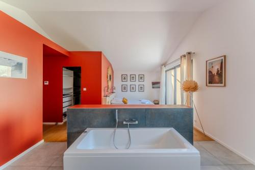 - une cuisine avec une grande baignoire blanche dans une chambre dans l'établissement Maison de Village en Pierre Piscine - 8 personnes, à Lansargues