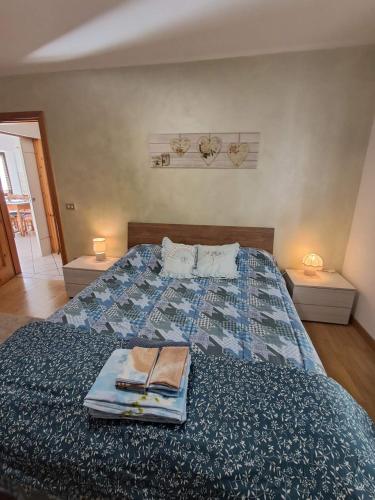 a bedroom with a bed with two books on it at VILLA ADRY Aosta Sarre Your freedom in Aosta