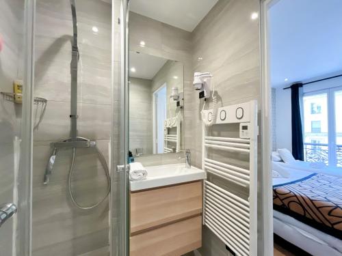 La petite salle de bains est pourvue d'une douche et d'un lavabo. dans l'établissement 105 - Urban Haussmann Opera, à Paris