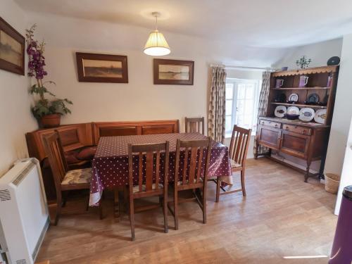 a dining room with a table and a couch at The Plover in Holt