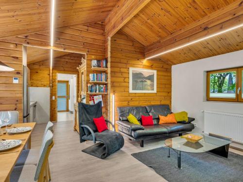 a living room with a couch and a table at Holiday Home Ferienhaus Bude 120 by Interhome in Bad Arolsen