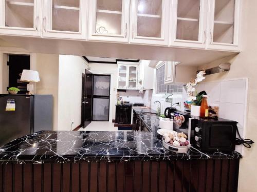 a kitchen with a counter with a bowl of fruit on it at EA4 Furnished Transient Room Apartment House Walking Distance to SM Ecoland & Davao Coastal Road and Near Ecoland Bus Terminal in Davao City