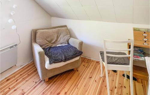 a room with a chair and a table and a ladder at Cozy Home In Örebro With Wifi in Örebro