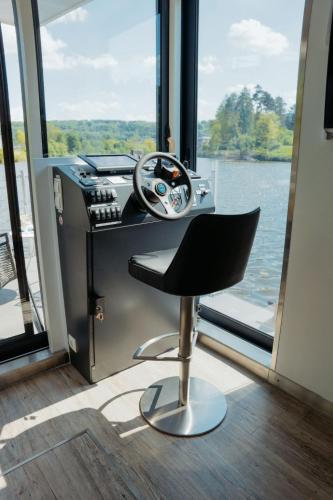 an office with a desk and a steering wheel at Holiday Home Floating Home-Hausboot in Merzig liegend by Interhome in Merzig