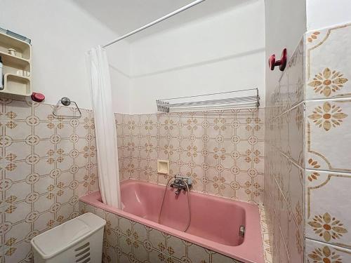 une baignoire rose dans une salle de bain avec toilettes dans l'établissement Appartement familial près de la plage avec parking - FR-1-770-54, à Saint-Cyr-sur-Mer