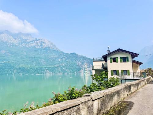 a house on a retaining wall next to a lake at Apartment Svasso by Interhome in Verceia