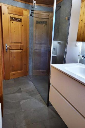 a bathroom with a sink and a toilet and a shower at Apartment Berna 2- Stock by Interhome in Lenk