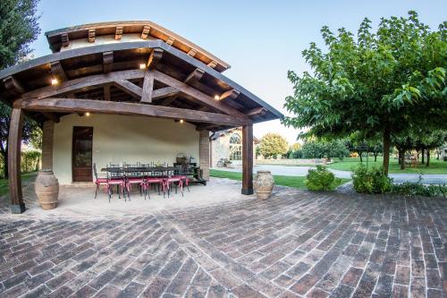 a pavilion with tables and chairs on a brick patio at Vocabolo Monache in Ponte Pattoli