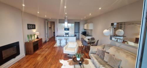 a living room with a couch and a table at Slick & Stylish - Large 1Bd in Heart of Cork City in Cork