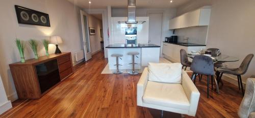 a living room with a kitchen and a dining room at Slick & Stylish - Large 1Bd in Heart of Cork City in Cork