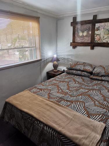 a bedroom with two beds and a butterfly on the wall at Jorstel in Grootvlei