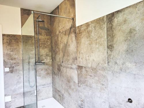 a shower with a glass door in a bathroom at Apartment Appartment sulle Viti by Interhome in Losone