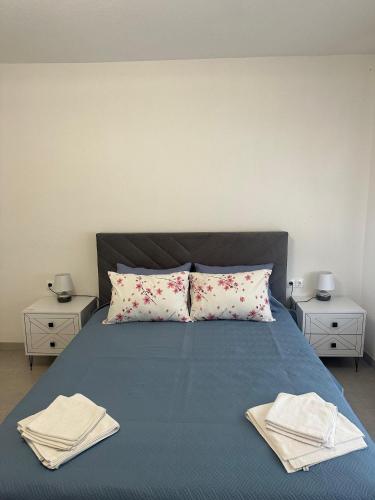 a bedroom with a bed with two towels on it at Apartments Bioland in Kulen Vakuf