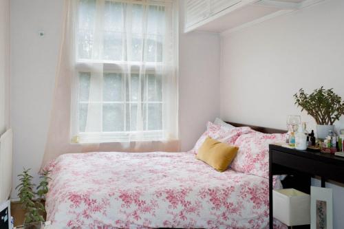a bedroom with a bed and a window at Central London Stays in London
