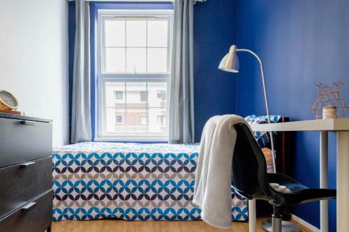 a bedroom with a bed with a window and a desk at Central London Stays in London