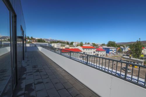 a balcony with a view of a city at Hofsbot Luxury Penthouse Apartment in Akureyri