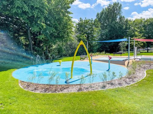 a pool with a water slide in a park at Holiday Home Tiny Haus wildLoisl by Interhome in Beilngries
