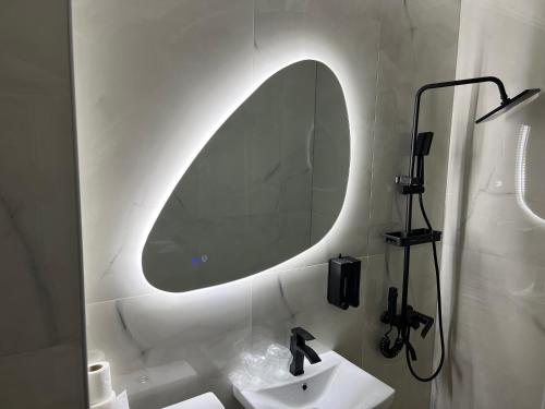 a bathroom with a sink and a mirror on the wall at Hotel Bosna in Kladanj