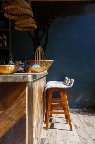 a stool sitting next to a counter with baskets on it at 沙溪坡上村花隐世民宿 in Diannan