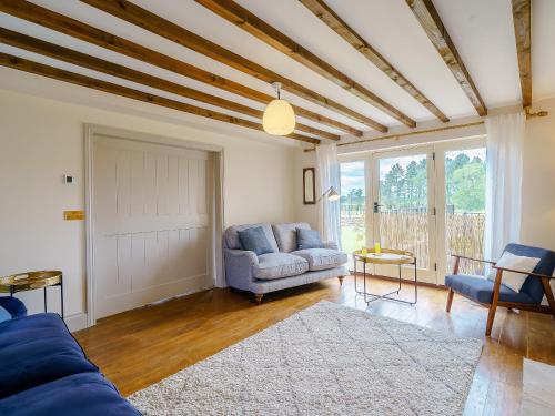 a living room with a couch and a table at Turnip Cottage in Newsham