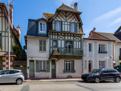 two cars parked in front of a house at Holiday Home Victor Hugo by Interhome in Deauville