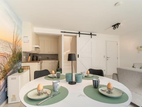a living room with a table and a kitchen at Apartment Havenhuys IV by Interhome in Bredene