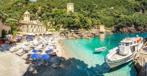 an aerial view of a beach with boats and umbrellas at Private Parking - Sea View - Terrace - AC in Lavagna