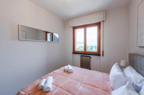 a bedroom with a bed with slippers on it at Private Parking - Sea View - Terrace - AC in Lavagna