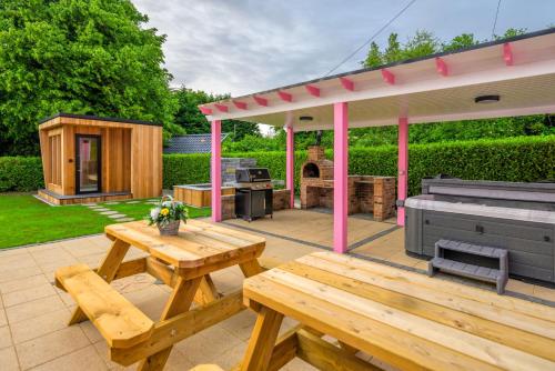 a patio with a picnic table and a pavilion at Lilys Pink House in Mayobridge