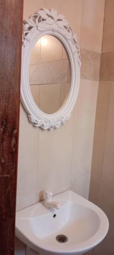 a bathroom with a white sink and a mirror at Spacious Holiday Let Wi-Fi & Private Amenities Oyibi in Oyibi