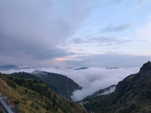 a view of a valley of clouds in the mountains at DS Residency Homestay, Chakrata in Chakrāta